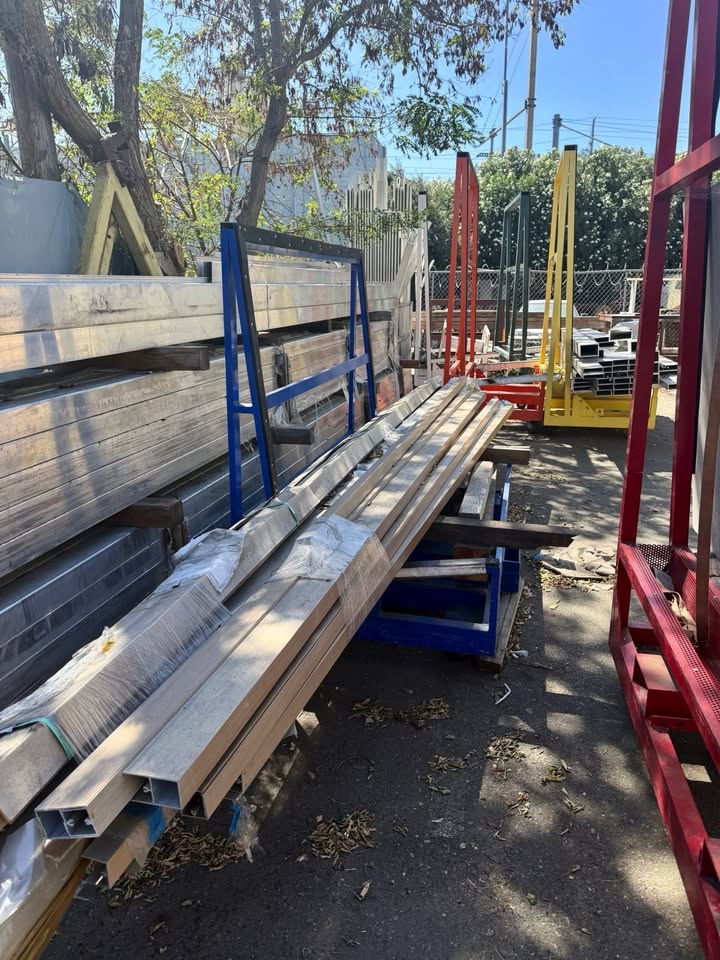Multiple aluminum A-frame carts holding fabrication material