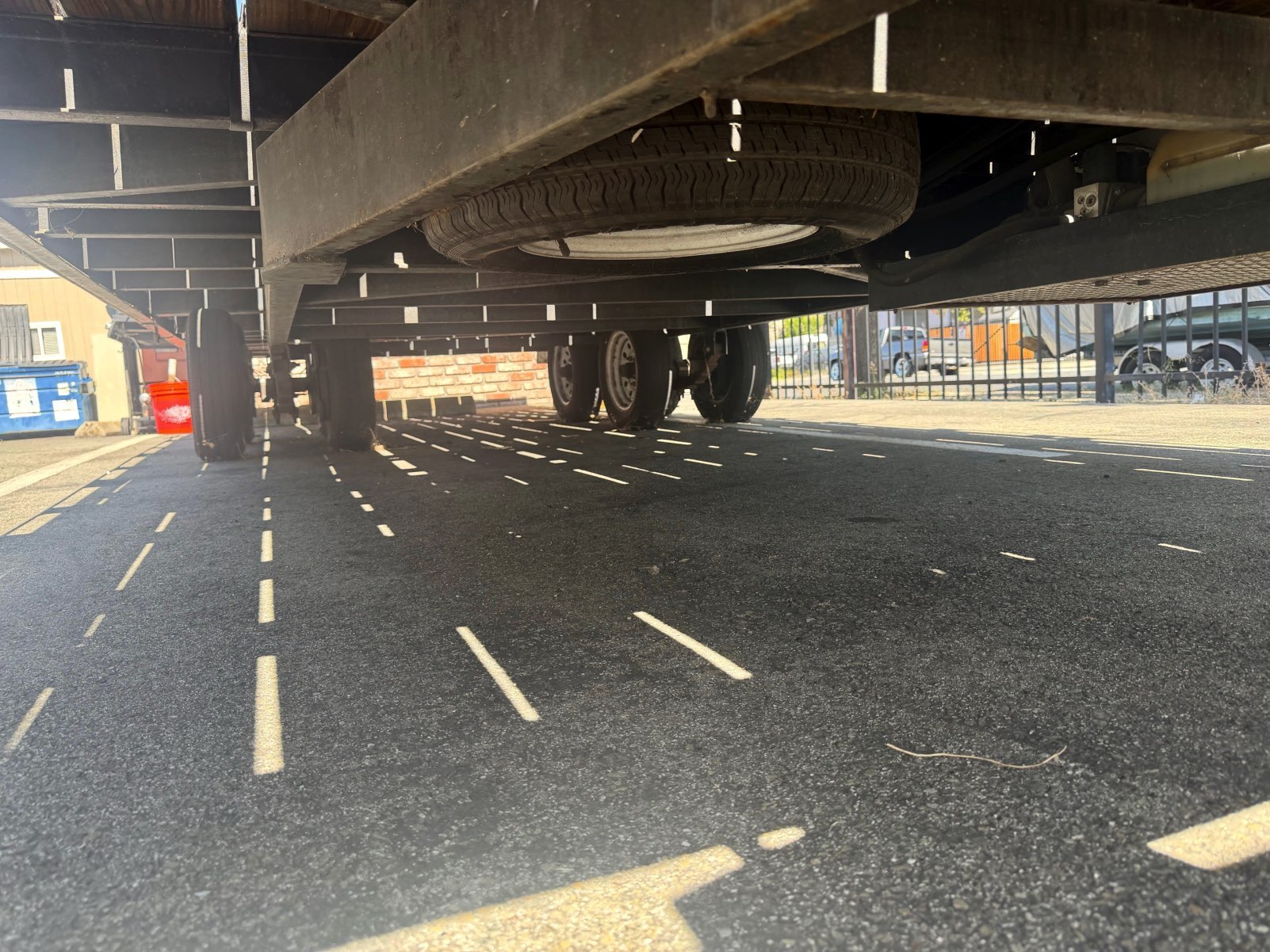 Spare tire mounted beneath the trailer frame